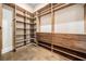 Spacious walk-in closet featuring wood shelving, drawers, and hanging space for optimal organization and storage at 481 W Davis Blvd, Tampa, FL 33606