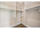 Functional walk-in closet with white shelving and hanging rods offering ample storage for clothing and accessories at 481 W Davis Blvd, Tampa, FL 33606