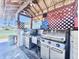 A sheltered grilling area, featuring stainless steel appliances and ample counter space for outdoor cooking at 5227 81St Lane N # 26, St Petersburg, FL 33709