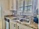 Functional kitchen area with stainless steel sink, ample countertop space, and natural light, ideal for meal preparation at 5227 81St Lane N # 26, St Petersburg, FL 33709