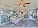 Spacious living room with a comfortable sofa, mirrored wall, and ample natural light, creating a welcoming atmosphere at 5227 81St Lane N # 26, St Petersburg, FL 33709