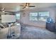 Bright living room featuring a comfortable sofa, carpeted floor, and natural light streaming through the windows at 5227 81St Lane N # 26, St Petersburg, FL 33709