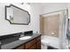 Comfortable bathroom with tub shower and vanity featuring modern fixtures and granite counters at 5310 Sanderling Ridge Dr, Lithia, FL 33547