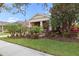 Inviting front exterior with well manicured landscape and brick paved driveway, complemented by mature trees and shrubs at 5310 Sanderling Ridge Dr, Lithia, FL 33547