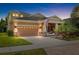 Inviting two-story home with a two car garage, a brick paved driveway and a cozy front porch with decorative landscaping at 5310 Sanderling Ridge Dr, Lithia, FL 33547
