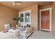 Inviting front porch with stylish seating, a ceiling fan, and a charming entrance door for relaxed outdoor living at 5310 Sanderling Ridge Dr, Lithia, FL 33547