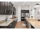 Kitchen featuring dark cabinets, stone countertops, an island, and stainless steel appliances at 5310 Sanderling Ridge Dr, Lithia, FL 33547