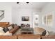 Comfortable living room featuring a large leather sofa, tile floors, natural light, and access to other rooms at 5310 Sanderling Ridge Dr, Lithia, FL 33547