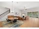 Open concept living and dining area with tile floors, modern furniture, and sliding glass doors to the backyard at 5310 Sanderling Ridge Dr, Lithia, FL 33547