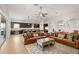 Bright and spacious living room featuring leather sofas, area rug, and view to the kitchen at 5310 Sanderling Ridge Dr, Lithia, FL 33547