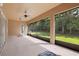 Wide screened patio ideal for enjoying outdoor living and dining with views of the green backyard at 5310 Sanderling Ridge Dr, Lithia, FL 33547