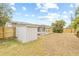 Backyard view, featuring grass, a shed, tropical landscaping, a patio, and a wood fence at 5893 32Nd N Ave, St Petersburg, FL 33710