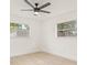 Bedroom featuring light wood floors, ceiling fan and two windows at 5893 32Nd N Ave, St Petersburg, FL 33710