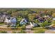 Residential neighborhood featuring well-maintained homes, mature trees, and a glimpse of a lake in the background at 5903 Nature Ridge Ln, Lithia, FL 33547