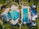 Stunning aerial view of a resort-style community pool with distinct areas for and adults amidst lush landscaping at 5903 Nature Ridge Ln, Lithia, FL 33547