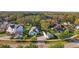 Residential neighborhood featuring well-maintained homes, mature trees, and a glimpse of a lake in the background at 5903 Nature Ridge Ln, Lithia, FL 33547