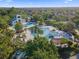 Expansive aerial view of a community pool, clubhouse, and lush landscaping in a neighborhood with many houses at 5903 Nature Ridge Ln, Lithia, FL 33547