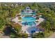 Aerial view of community pool with water slide, splashpad, and lounge area at 5903 Nature Ridge Ln, Lithia, FL 33547