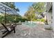 Relaxing backyard features a sparkling pool, spa, umbrella, and comfortable lounge chairs at 5903 Nature Ridge Ln, Lithia, FL 33547