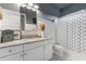 Stylish bathroom featuring shiplap accent wall, granite countertop, and decorative accents at 5903 Nature Ridge Ln, Lithia, FL 33547