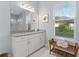 Bathroom featuring a double sink vanity, white granite countertop, and a glass-enclosed shower at 5903 Nature Ridge Ln, Lithia, FL 33547