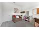 Cozy bedroom features chair, neutral carpet, with a door for privacy at 5903 Nature Ridge Ln, Lithia, FL 33547