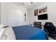 Teen bedroom with blue metal frame bed, black desk, posters, and wall mounted TV at 5903 Nature Ridge Ln, Lithia, FL 33547