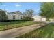Attractive home with a well-manicured lawn, mature trees, and a three-car garage at 5903 Nature Ridge Ln, Lithia, FL 33547