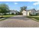Charming single-Gathering home with a long brick driveway and a spacious three-car garage at 5903 Nature Ridge Ln, Lithia, FL 33547