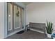 Welcoming front porch with a wooden bench, stylish lantern, and lush greenery at 5903 Nature Ridge Ln, Lithia, FL 33547