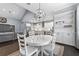 Open kitchen with gray and white cabinets, updated lighting, and stainless steel appliances at 5903 Nature Ridge Ln, Lithia, FL 33547