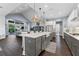 Open concept kitchen with a large center island, stainless appliances, and hardwood floors at 5903 Nature Ridge Ln, Lithia, FL 33547