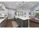 Beautiful modern kitchen with large island, white countertops, gray cabinets and stainless appliances at 5903 Nature Ridge Ln, Lithia, FL 33547