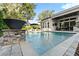 Stunning pool with elegant water feature and an outdoor kitchen area, perfect for entertaining at 5903 Nature Ridge Ln, Lithia, FL 33547