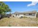 Backyard view with small garden with flowers, AC Unit and wooden fence at 6416 Lomand Ave, New Port Richey, FL 34653