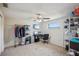 Bedroom has functional furniture, including a computer desk and closet, with a ceiling fan and natural light at 6416 Lomand Ave, New Port Richey, FL 34653