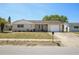 Charming single-story home with a well-manicured lawn, quaint front porch, and attached garage at 6416 Lomand Ave, New Port Richey, FL 34653
