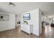 Open hallway with tile flooring, leading to living areas and a view of the kitchen at 6416 Lomand Ave, New Port Richey, FL 34653