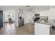 Well-lit kitchen with stainless steel appliances, plenty of storage, and breakfast bar at 6416 Lomand Ave, New Port Richey, FL 34653