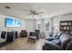 Comfortable living room with large windows, plush seating, and built-in bookcase at 6416 Lomand Ave, New Port Richey, FL 34653