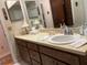 Bathroom featuring long vanity with sink, commode, and full size mirror at 6703 Peachtree Dr, Temple Terrace, FL 33617
