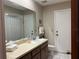 Well-lit bathroom with tile floors, a wide mirror, and a clean, functional design at 6703 Peachtree Dr, Temple Terrace, FL 33617