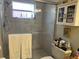 Bright bathroom with vanity, framed mirror, and glass-enclosed tiled shower at 6703 Peachtree Dr, Temple Terrace, FL 33617