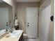Well-lit bathroom featuring tile floors, a large mirror, and a convenient shower stall at 6703 Peachtree Dr, Temple Terrace, FL 33617