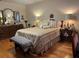Inviting bedroom with hardwood floors, a comfortable bench, and ample dresser storage at 6703 Peachtree Dr, Temple Terrace, FL 33617