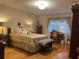 Comfortable bedroom with hardwood floors, a bench, a work desk, and plenty of natural light at 6703 Peachtree Dr, Temple Terrace, FL 33617