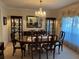 Elegant dining room with a chandelier, china cabinets, and a large dining table at 6703 Peachtree Dr, Temple Terrace, FL 33617