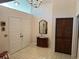 Welcoming foyer featuring double doors, a chandelier, and neutral tile flooring at 6703 Peachtree Dr, Temple Terrace, FL 33617