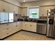 Bright kitchen with granite counters, white cabinets, and stainless steel appliances at 6703 Peachtree Dr, Temple Terrace, FL 33617
