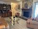Spacious living room with a stone fireplace, tile flooring, and comfortable furnishings at 6703 Peachtree Dr, Temple Terrace, FL 33617